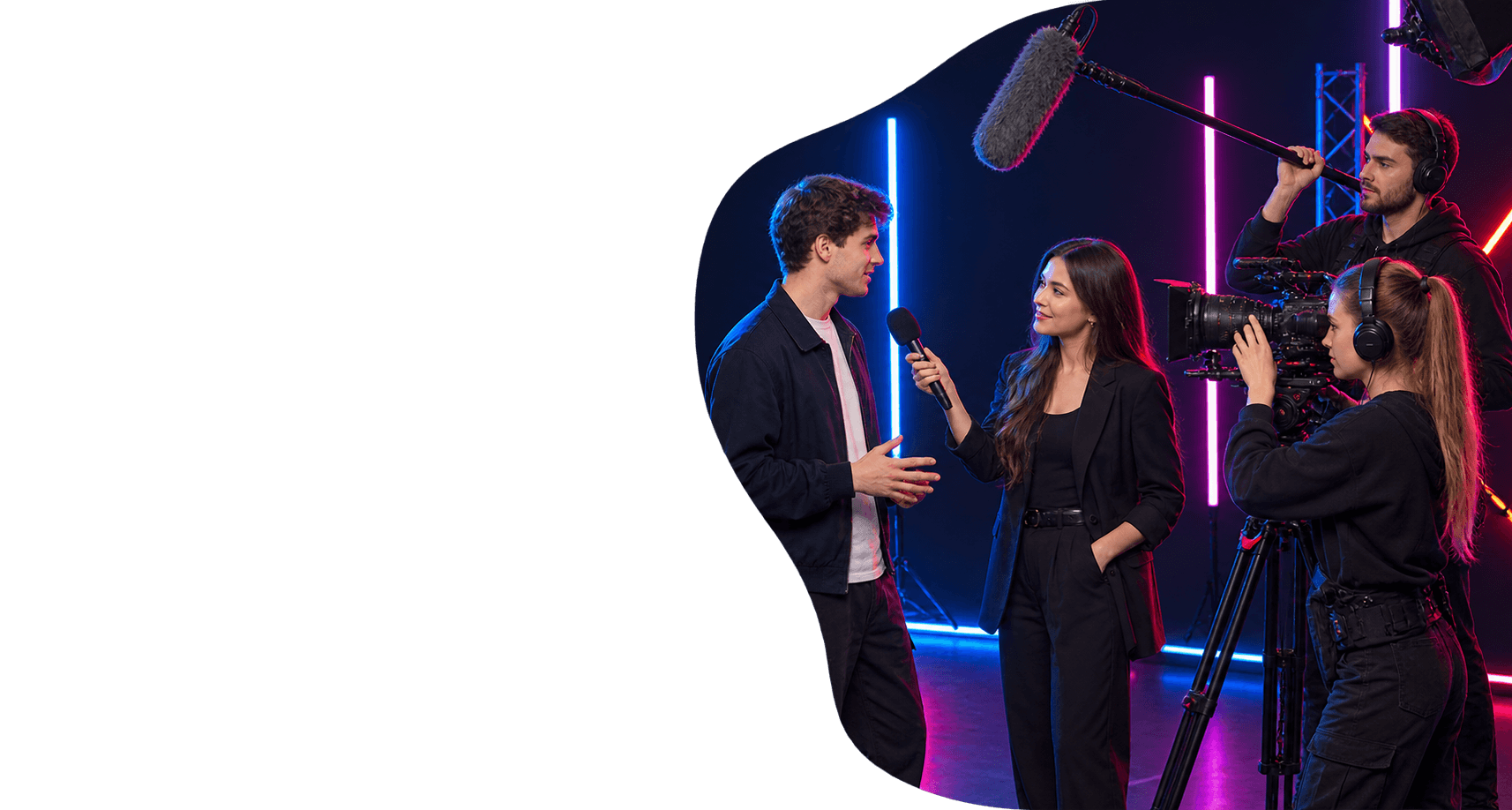 The MediaPro team films an interview in a neon studio